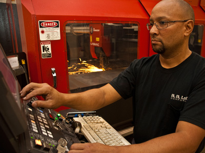 Employee Performing Surface Treatment for Sheet Metal